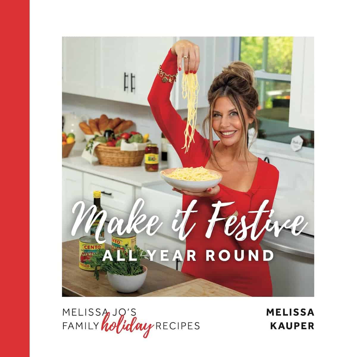 A smiling woman in a red dress stands in a kitchen, holding a plate of pasta and lifting noodles with one hand. The text reads Make it Festive All Year Round and Melissa Jos Family Holiday Recipes by Melissa Kauper.