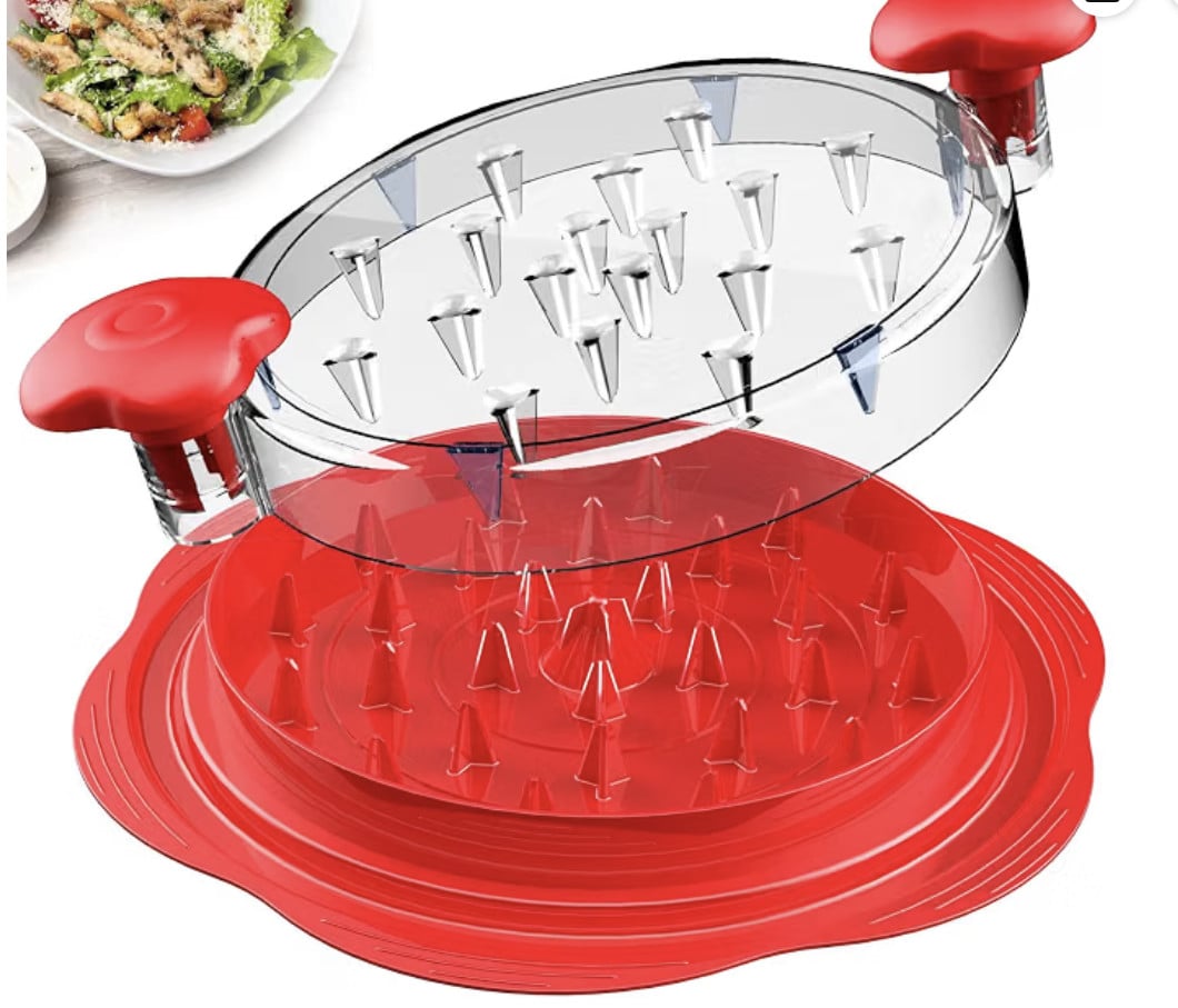 Round red and clear plastic kitchen tool with spikes, likely used for slicing or cutting food. Two red handles are on opposite sides of the top piece. Food dish partially visible in the background.